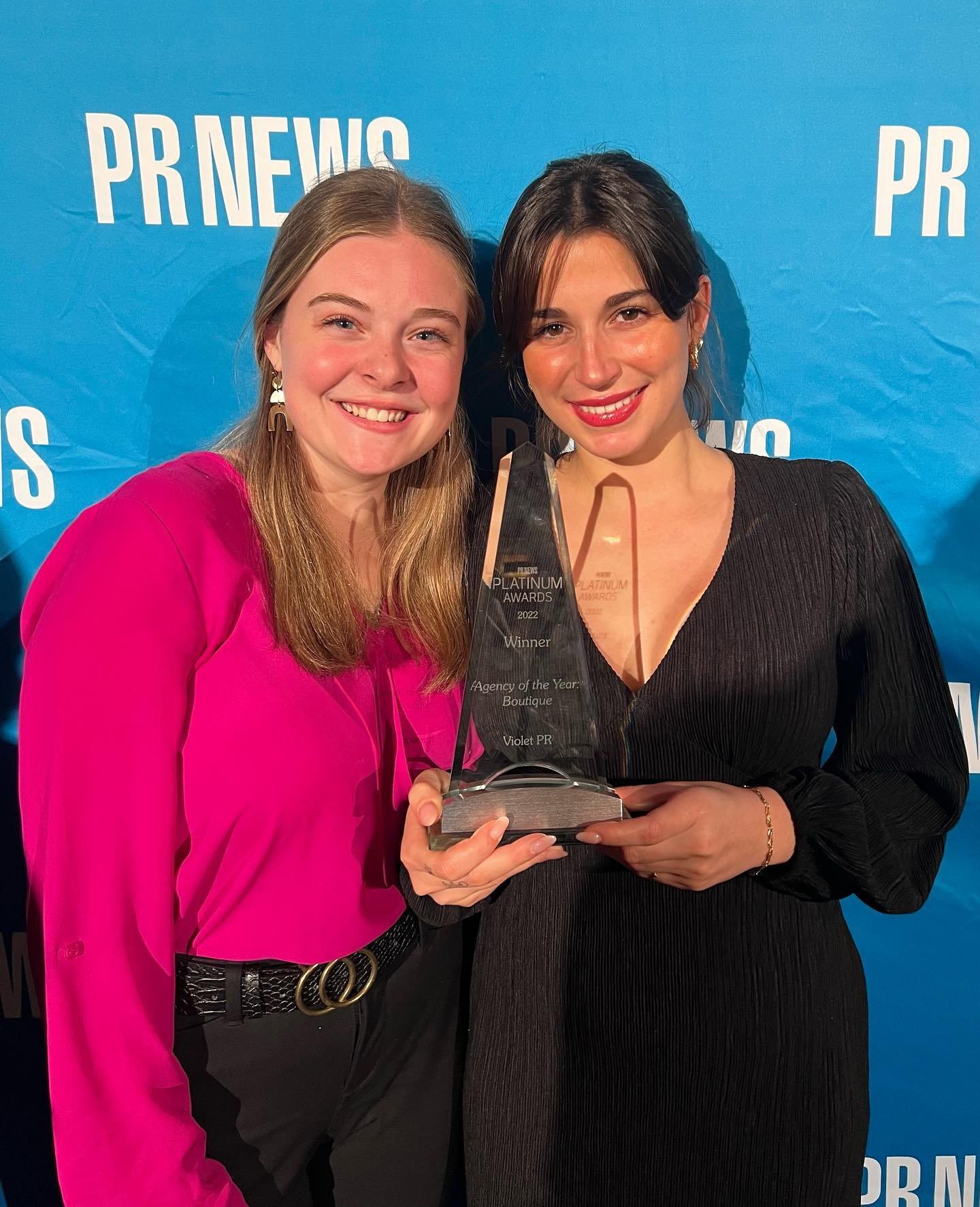 account executive sam and account manager alexa accept the award on behalf of the violet pr team